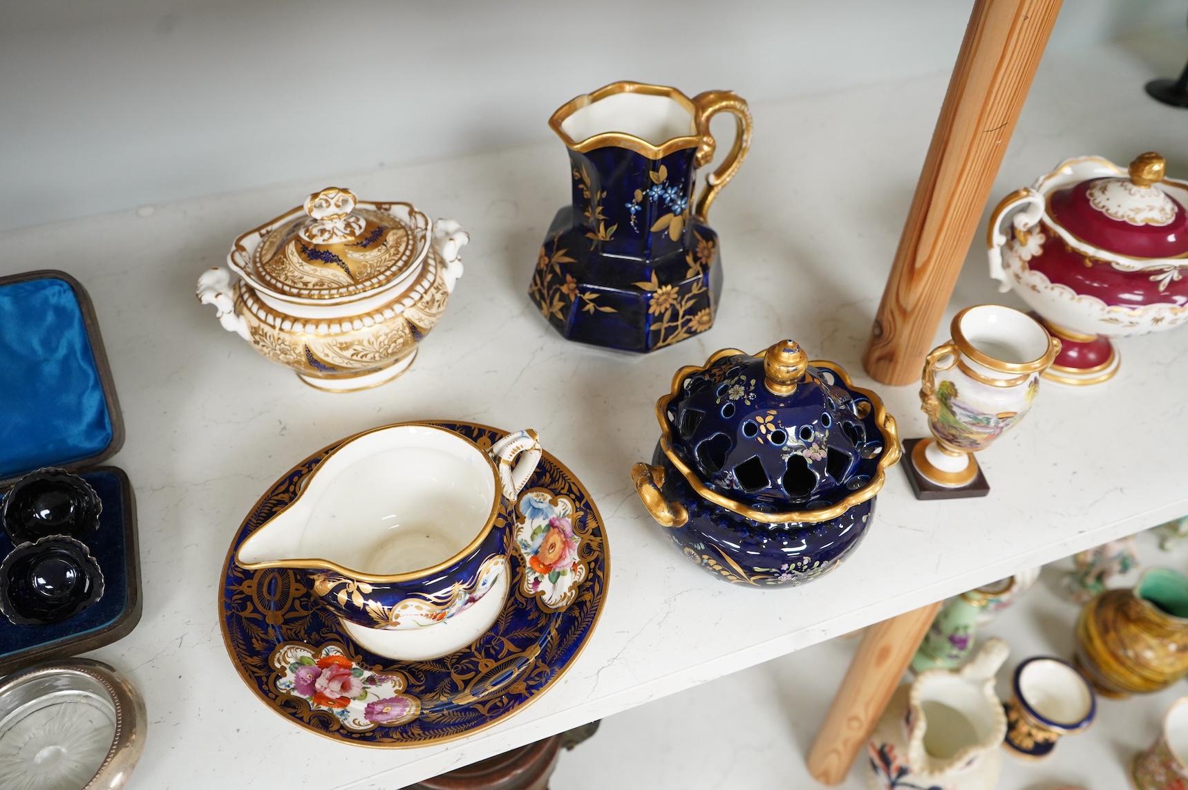 A Group of early 19th century English porcelain; to sauce tureens and covers, one with stand, a covered sugar bowl, a two handled vase, a pot pourri vase and cover, a milk jug and a hydra shaped jug, largest 16cm high